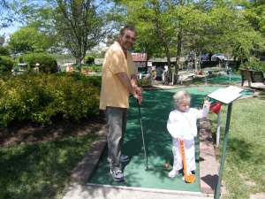Daddy and Elizabeth playing put put golf at Young's Dairy 25 May 2008