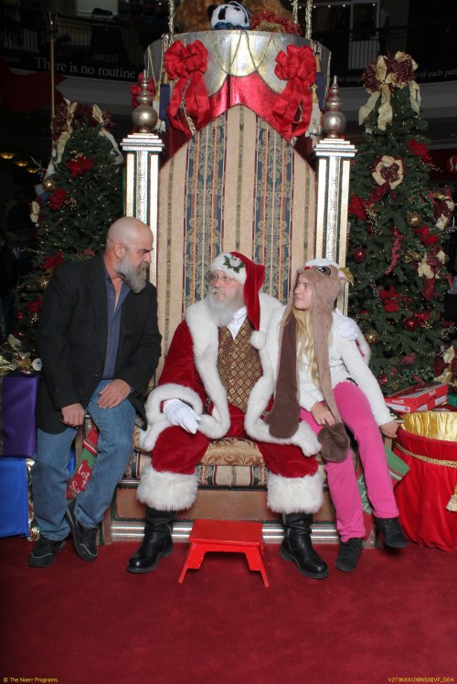 Daddy telling Santa Claus a story.